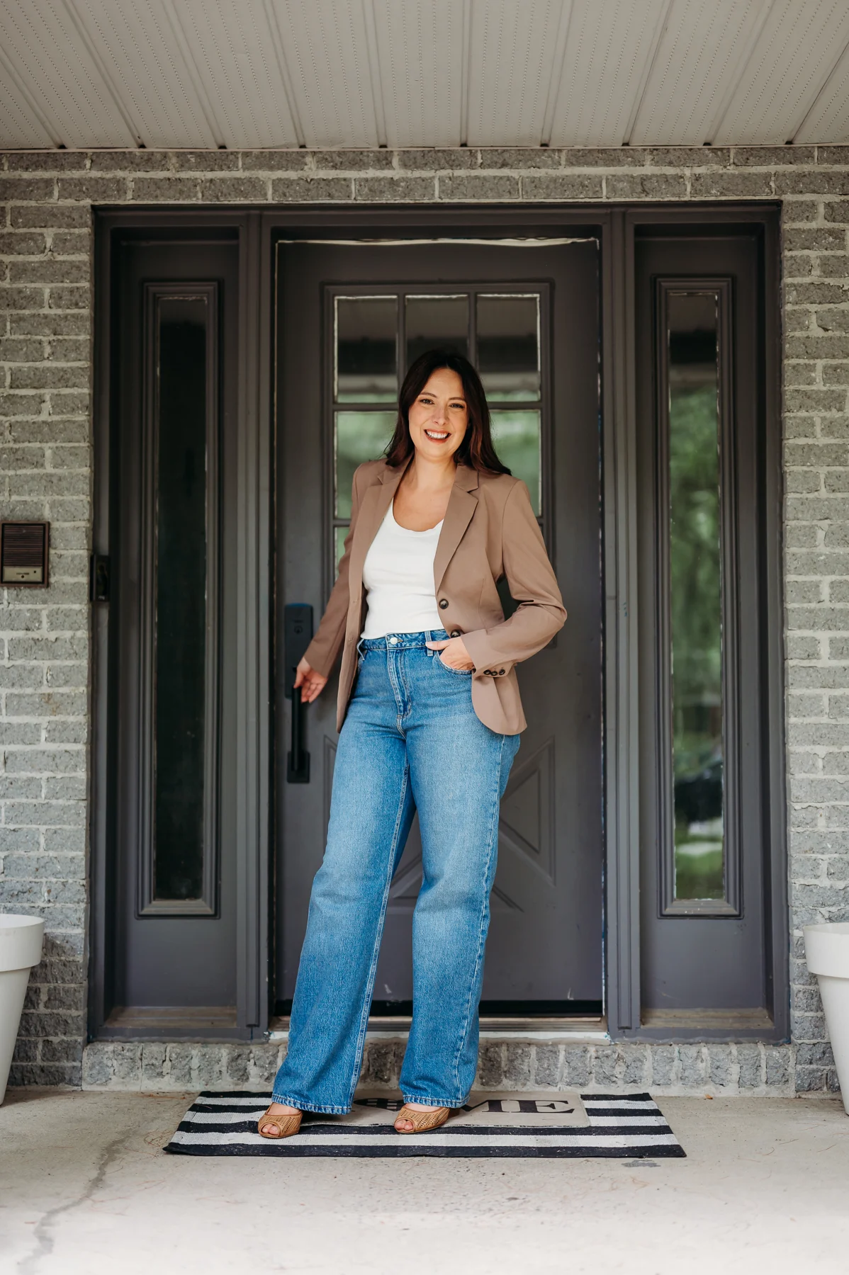 Karine standing at the entrance to a house
